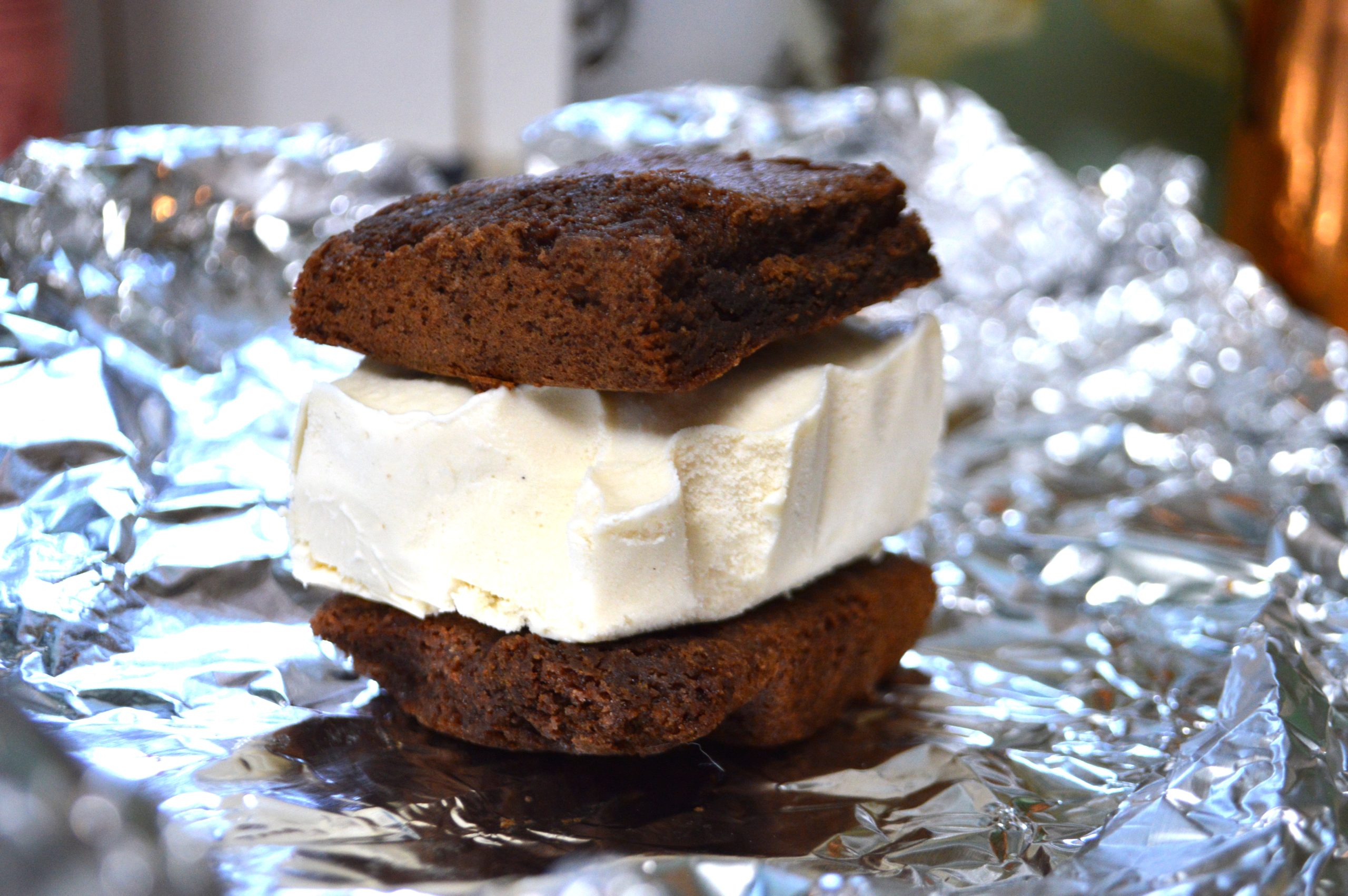 DSC_5472 A homemade ice cream sandwich with vanilla ice cream between chocolate cookies on tin foil